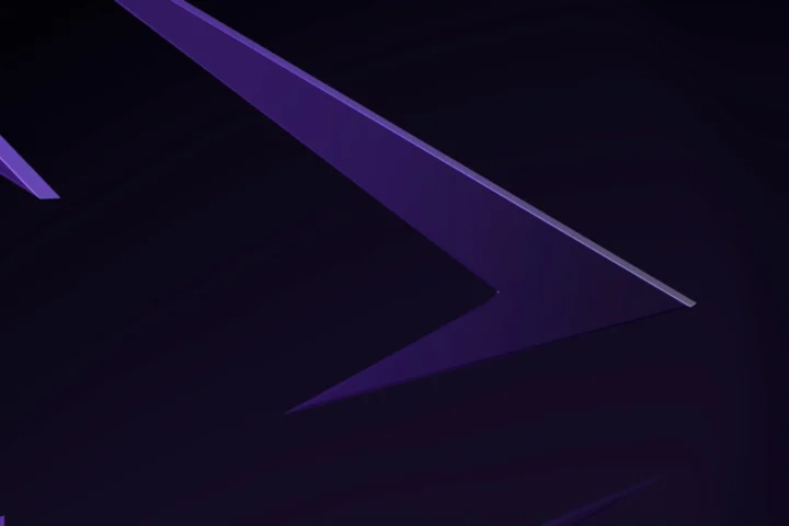 The arrowhead of the violet Innovara sculpture in low violet light
