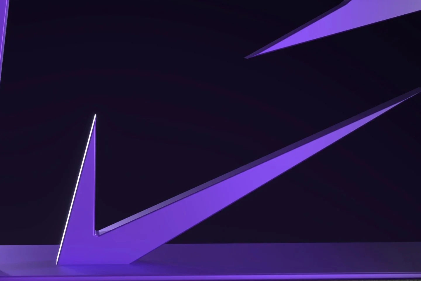 The lower stroke of the violet Innovara sculpture sweeping diagonally across a dark set