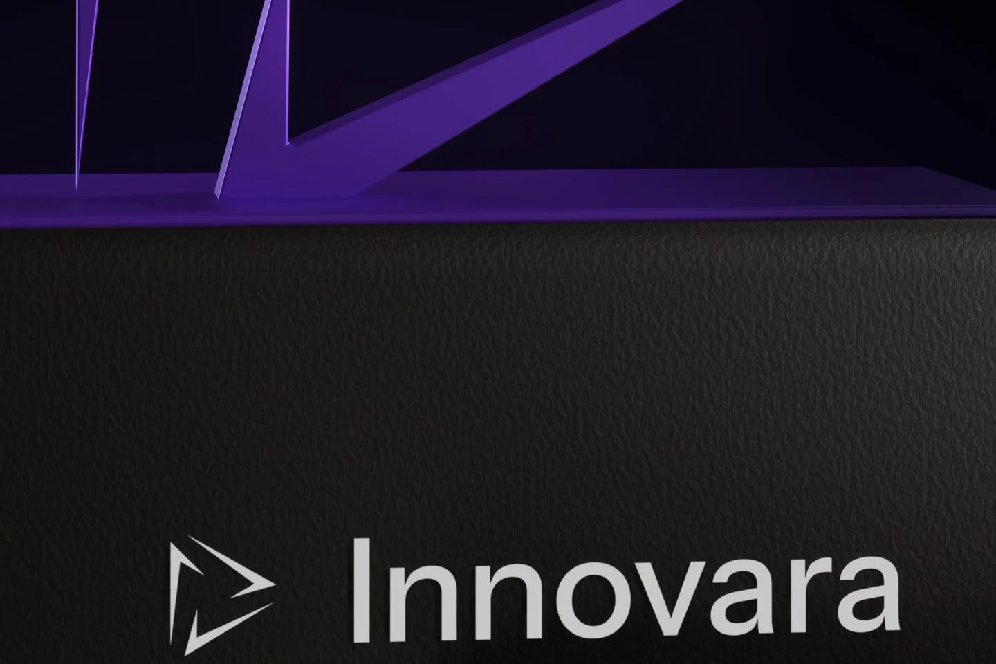 The base of the violet Innovara sculpture above a charcoal plinth carrying the Innovara lockup