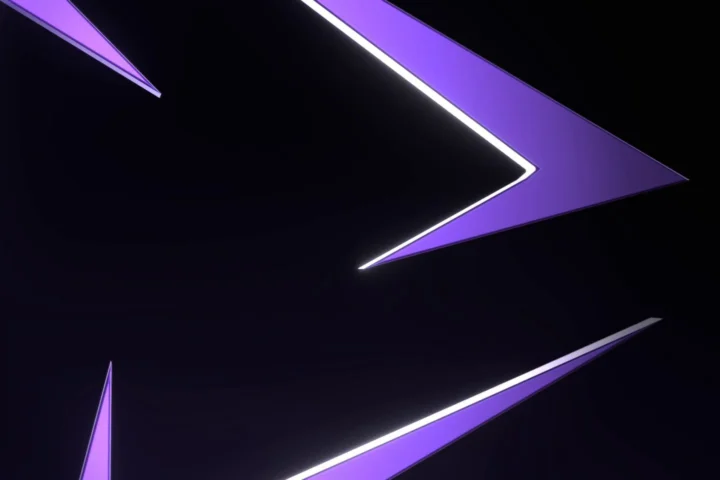 The point of the violet Innovara sculpture, its edges lit by a thin bright line against black